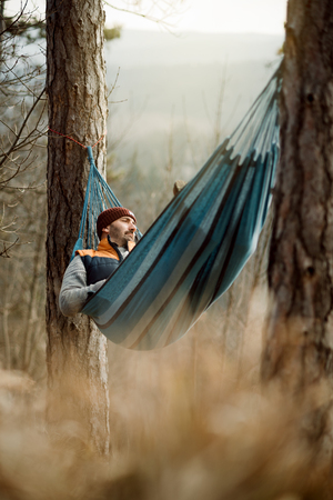 Young man in hammockの写真素材