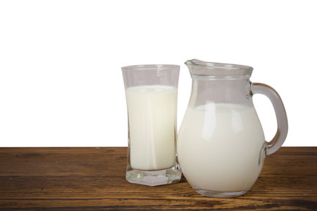 Photo of milk on wooden desk isolatedの写真素材