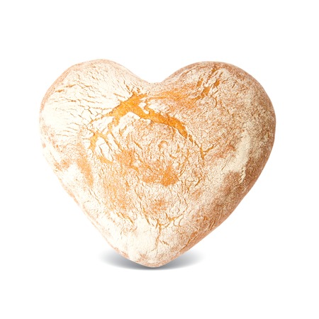 Bread in a heart shape isolated on whiteの写真素材
