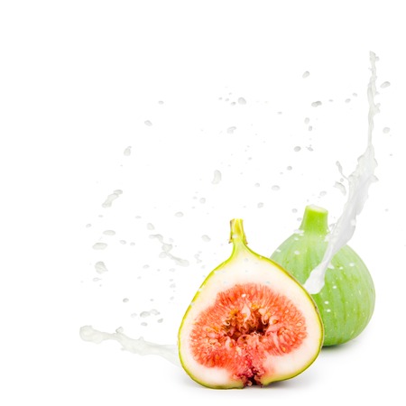 Photo of fig with milk splash isolated on whiteの写真素材
