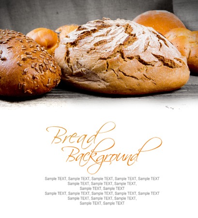 Bread with buns on wooden background with white space for textの写真素材