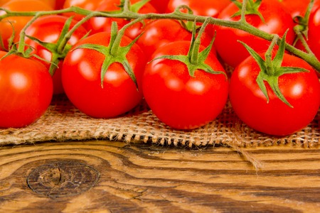 Photo of tomatoes on wooden boardの写真素材