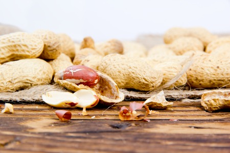 Photo of peanuts on wooden board