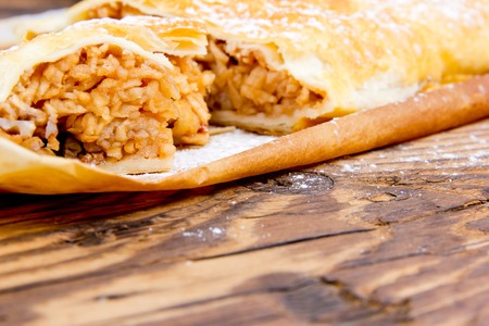 Photo of sliced apple strudel on wooden boardの写真素材