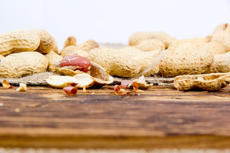 Photo of peanuts on wooden board