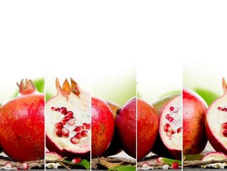 Photo of pomegranates with slice and leaves on burlap with white spaceの写真素材
