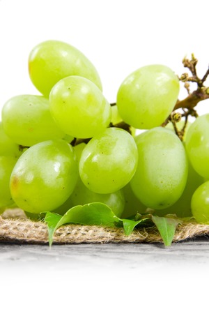Photo of green grapes with leaves and white space for textの写真素材