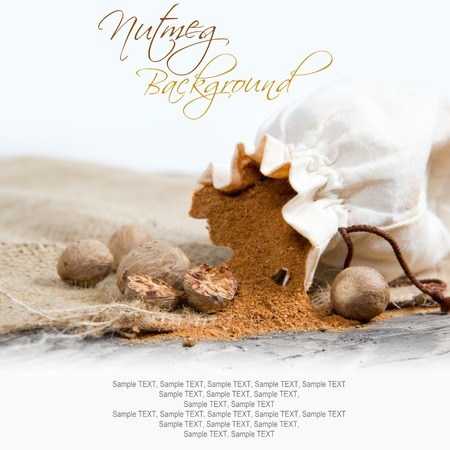 Photo of bag full of nutmeg powder on burlap with white spaceの写真素材