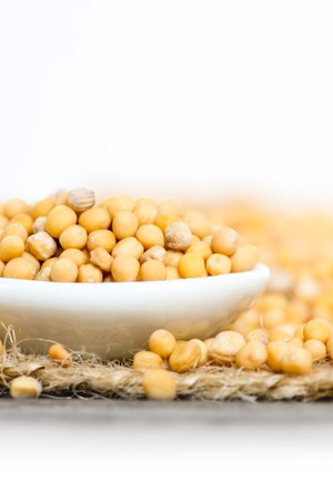 Macro photo of spoon full of mustard seeds on burlap with white space; low depth of focusの写真素材
