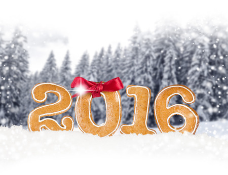 Photo of Christmas sweets 2016 number on Christmas abstract background with falling snow and white...