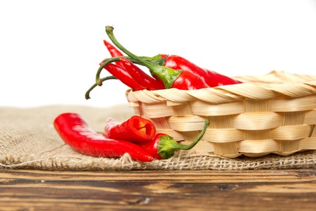 Photo of fresh chili peppers in a basket; healthy eating; white space for textの写真素材