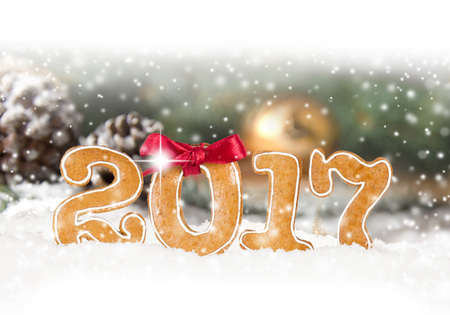 Photo of Christmas sweets 2017 number on Christmas abstract background with falling snow and white spaceの写真素材