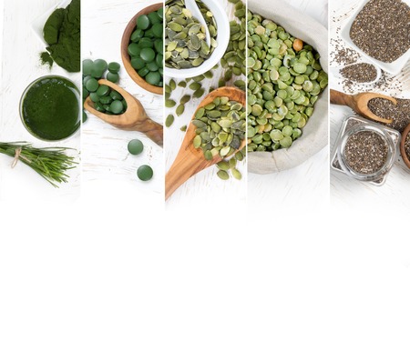 Top view of mixed colorful chlorella and seeds scattered on white wooden surface; dieting and detoxication conceptの写真素材