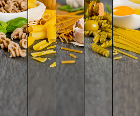 Photo of mixed various kinds of pasta on gray slate tile surfaceの写真素材