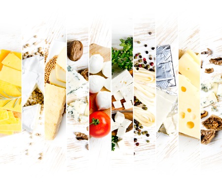 Top view of various kinds of cheese abstract mix with spice and herbs on wooden boards; white space for textの写真素材