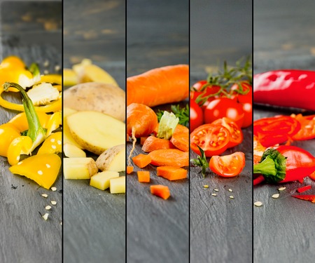 Photo of colorful mix stripes with cut vegetables on gray slate tile; healthy eating conceptの写真素材