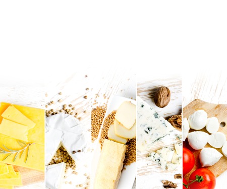 Top view of various kinds of cheese abstract mix with spice and herbs on wooden boards; white space for textの写真素材