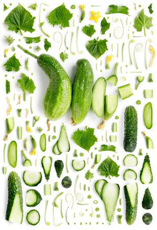 Large collection of green cucumber vegetable pieces, slices and leaves isolated on white background. Top view. Seamless abstract pattern.の写真素材