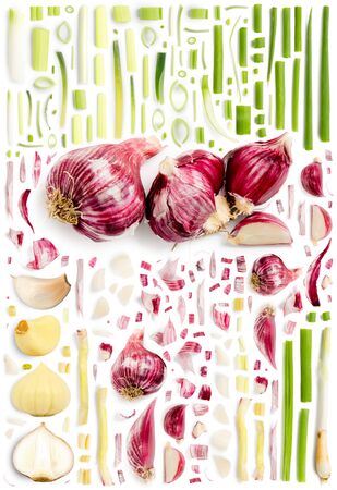 Large collection of garlic vegetable pieces, slices and leaves isolated on white background. Top view. Seamless abstract pattern.の写真素材