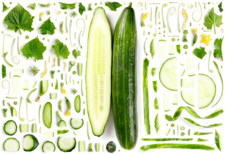 Large collection of green cucumber vegetable pieces, slices and leaves isolated on white background. Top view. Seamless abstract pattern.の写真素材