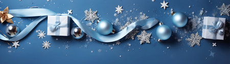 Christmas gifts, balls, decorations and snowflakes in a row on a blue surface. Horizontal composition, flat lay, top view.の素材