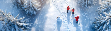 Aerial view of children building snowman in winter forest with snow covered surface, spruce trees and sunset in the background.の素材