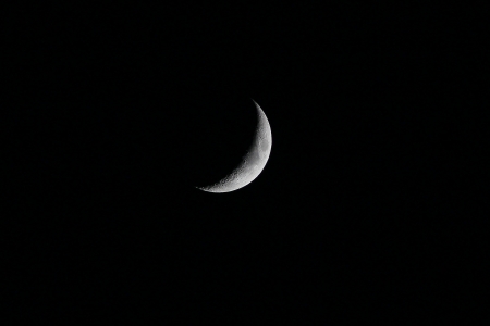 Crescent moon on dark skyの写真素材