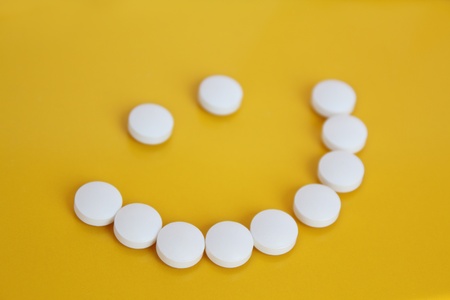 Smile from tablets on an orange backgroundの写真素材