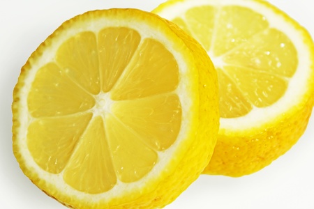 Two pieces of a juicy lemon on a white backgroundの写真素材