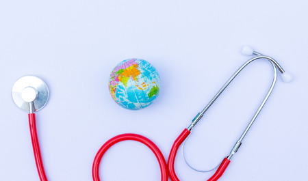 World health day, Healthcare and medical concept. Stethoscope on light blue wooden table background texture.の写真素材