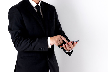 Business man using smart phone over white background with copy space for advertisers. Business concept or Online business concept.の写真素材