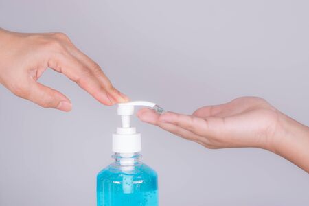 close-up mother's hand and boy applying sanitizer gel on hands anti coronavirus or covid-19 in studio on white background. Protective covid-19 outbreak concept.の写真素材
