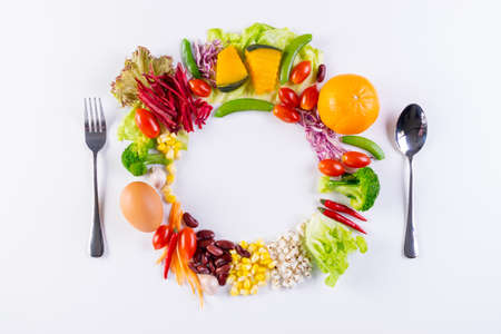 World food day or vegetarian day concept. Top view of fresh vegetables, fruit, herbs and spices with a empty on white paper background.の写真素材