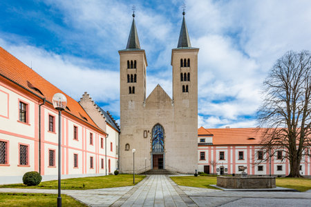Milevsko, Czech Republic - February 22 2020: View of the Premonstratensian Monastery from 12th century and the Romanesque church of Annunciation of Virgin Mary. Blue sky and white clouds.のeditorial素材