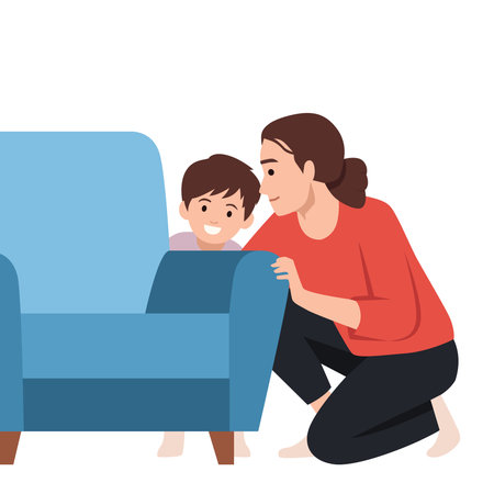 Curious mother and her smiling son kneel beside a blue sofa, peeking behind it. Flat vector illustration isolated on white backgroundのイラスト素材