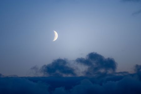 The moon with seen details and edge of a cloudの写真素材
