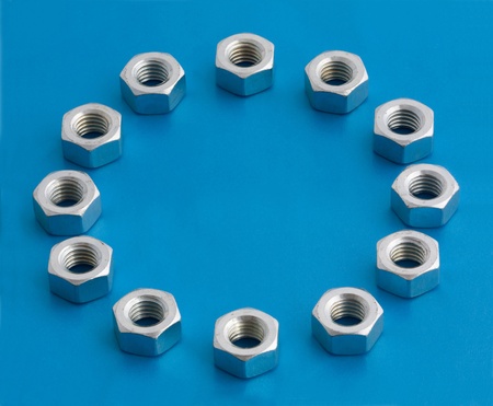 twelve hexagonal nuts on blue backgroundの写真素材