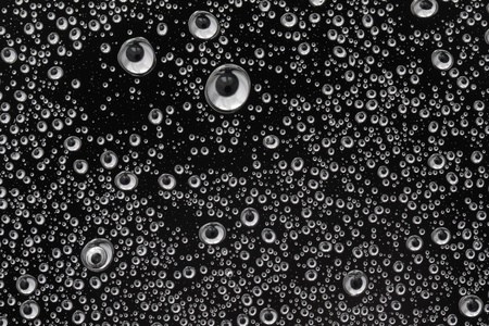 texture from water droplets on the black transparent surface