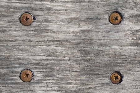 Old wooden board with rusted screws and cracks. Backgroundの写真素材