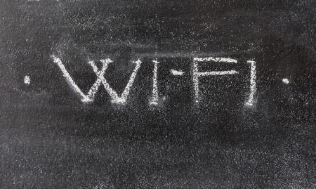WiFi letters chalk on black wallの写真素材