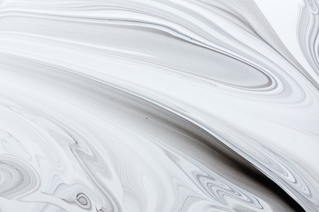 Mix of a white and black paint, closeup.の写真素材