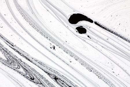Mix of a white and black paint, closeup.の写真素材
