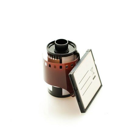 Analog Camera film roll and Digital dslr Camera memory card side by sideの写真素材