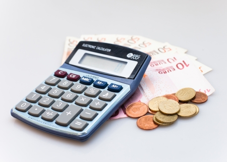 Calculator, Euro Notes And Euro coins isolated on whiteの写真素材