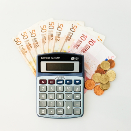 Calculator, Euro Notes And Euro coins isolated on whiteの写真素材
