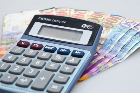 Arrangement of Calculator, Israeli Shekel notes and coins isolated on whiteの写真素材