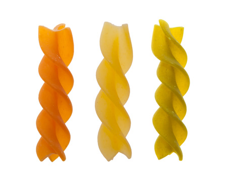 Red Yellow and green Fusilli pasta isolated on whiteの写真素材