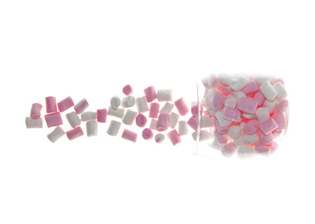 Open Glass jar of pink and white Marshmallow isolated on whiteの写真素材