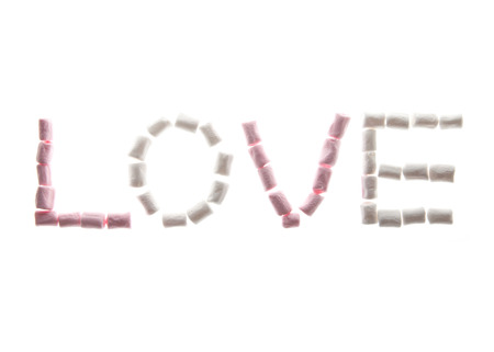 The Word LOVE written in Pink and white Marshmallow isolated on whiteの写真素材