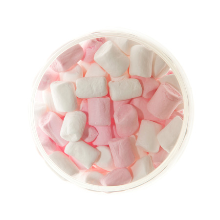 Open Glass jar of pink and white Marshmallow view from above isolated on whiteの写真素材